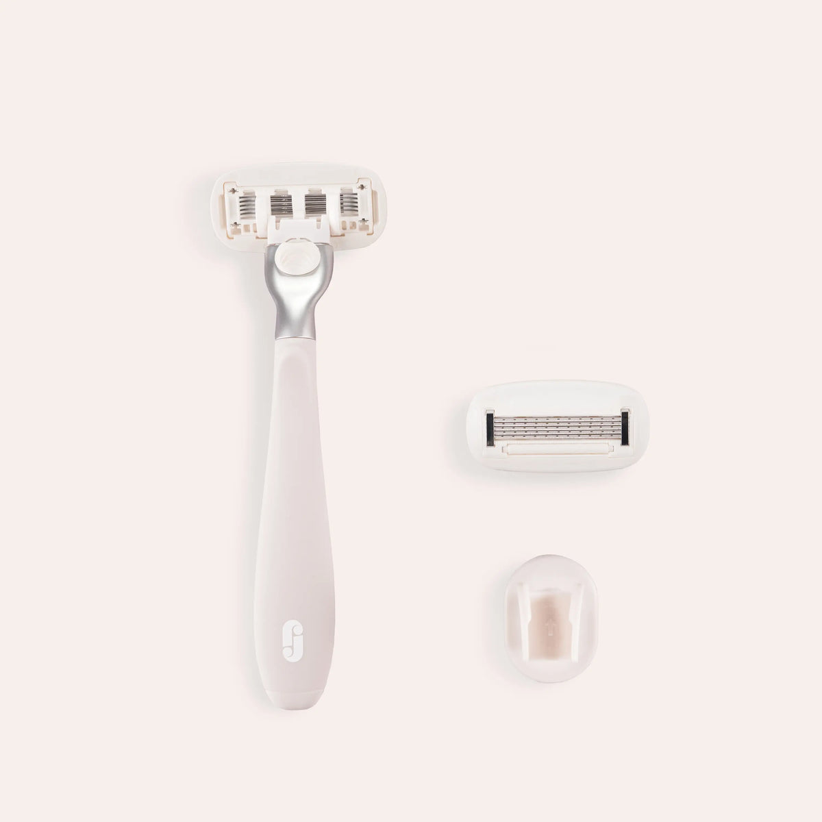 Der Razor-Cotton-Candy ohne Case liegt mittig, neben Rasierklinge und Halterung.